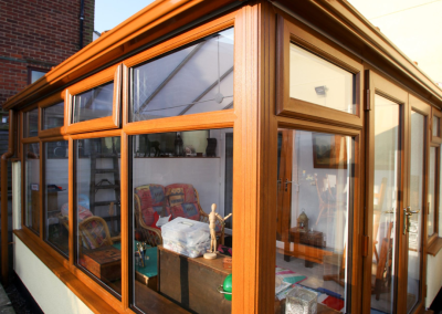 Corner view of an orangery with a light brown colour scheme