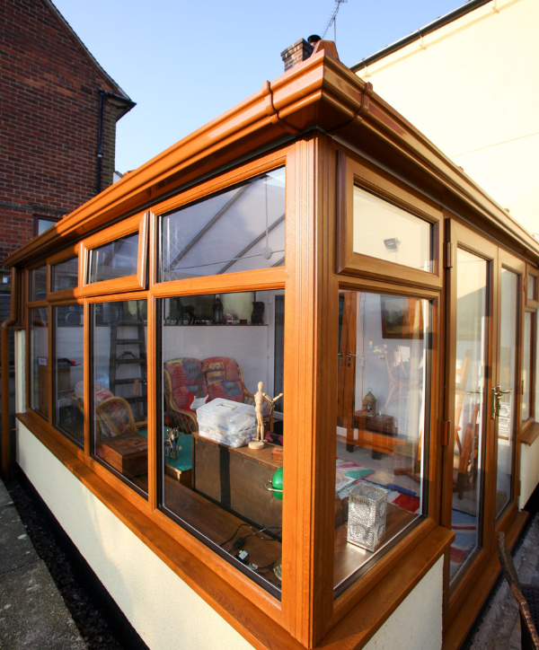 Corner view of an orangery with a light brown colour scheme