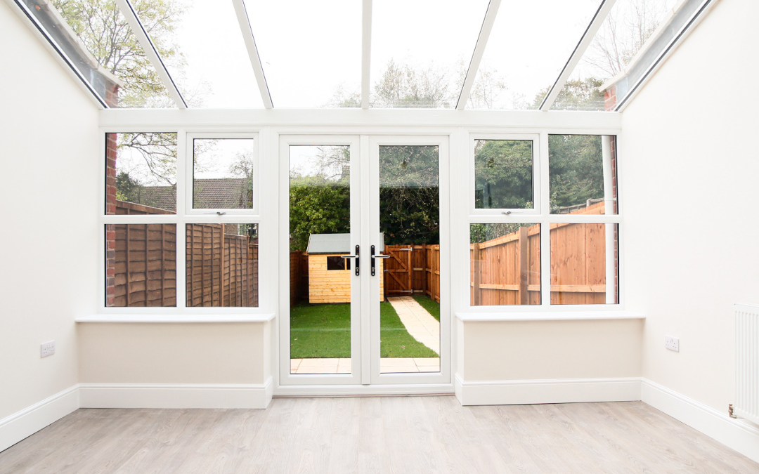 Daytime modern conservatory interior with square panels and a white and light-tone wood colour scheme
